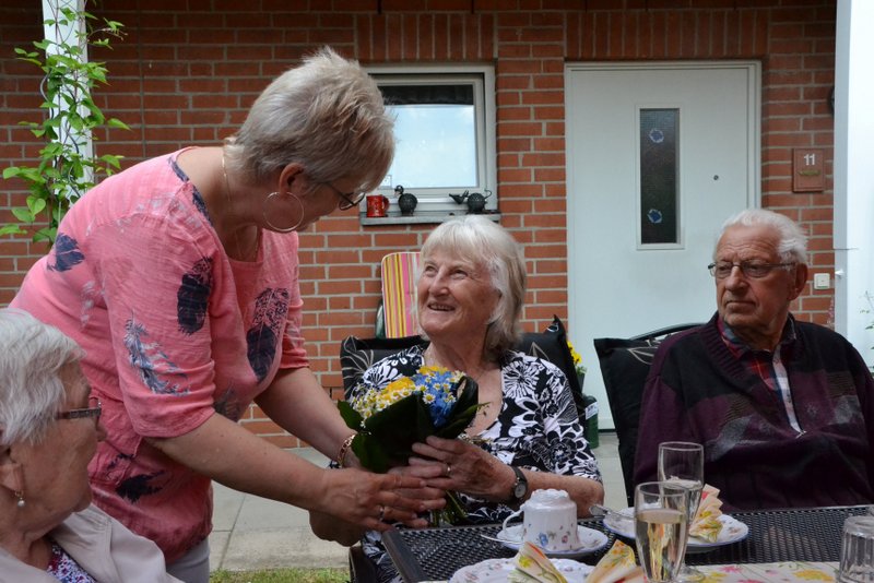 Bild zeigt Bewohnerin Ursula Möller bei der Empfangnahme eines Blumengrußes